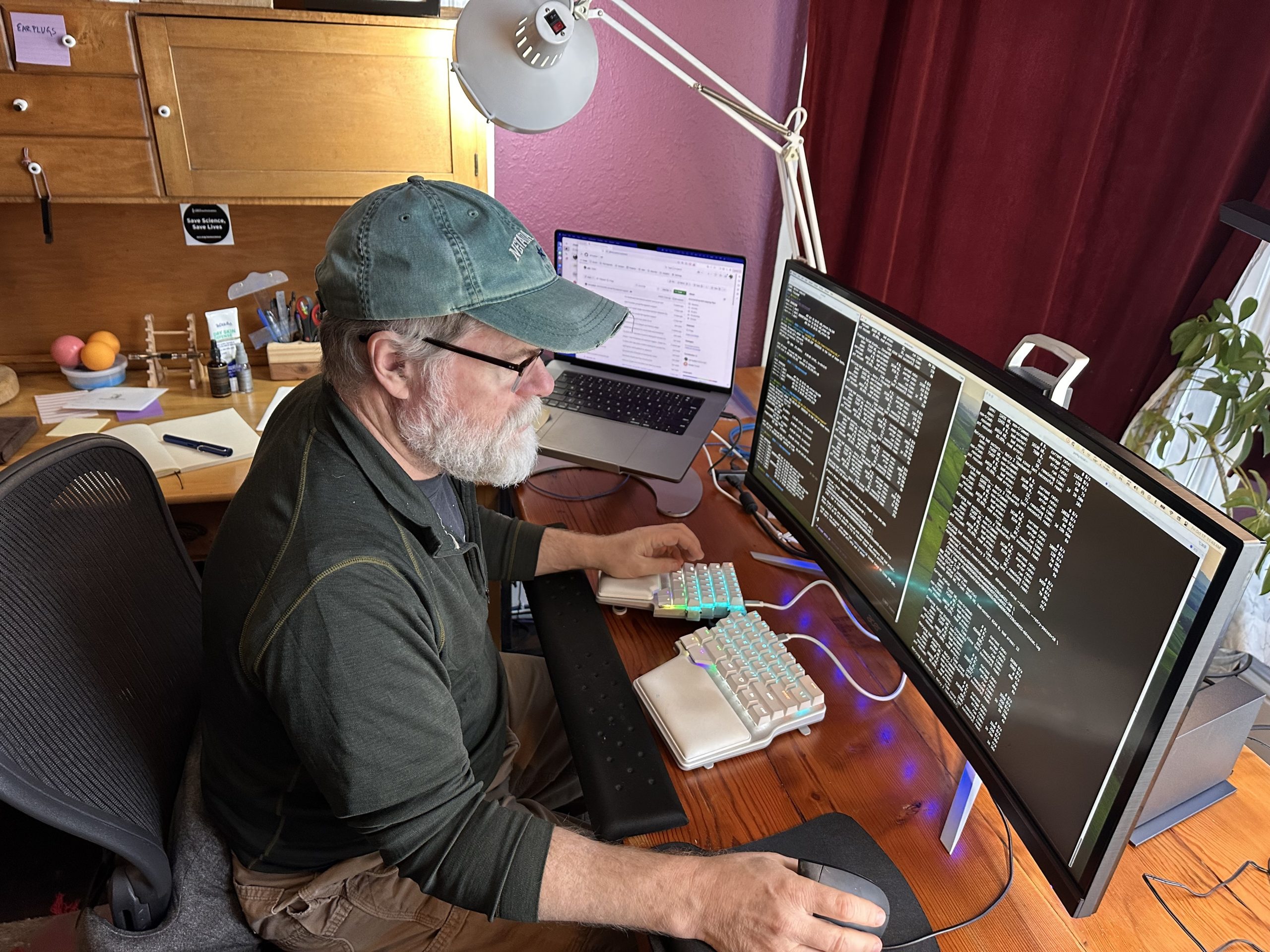 Patrick Ball working at three monitors